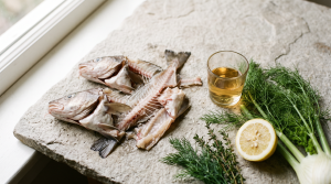 Fish bone broth ingredients laid out with fish frames, fennel, and lemon for a quick simmer